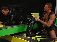 Man in latex getting a big black dildo